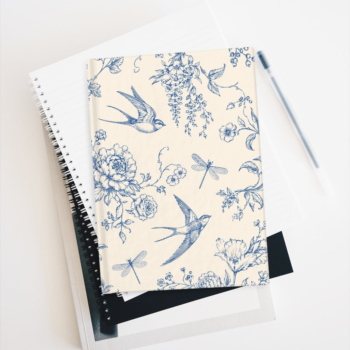 Toile de Jouy swallows journal resting against a spiral notebook