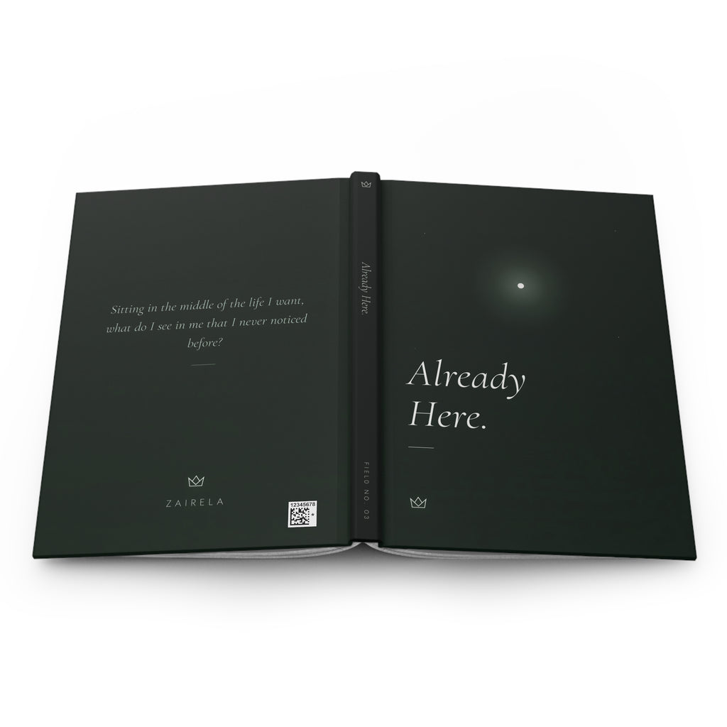 Already Here journal laid open to show the full-wrap design: the question on the back, FIELD NO. 03 on the dark spine, and the glowing star on the front