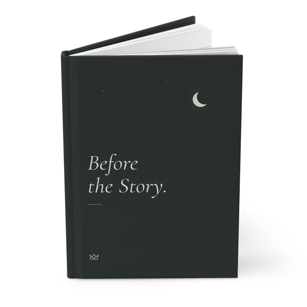 Before the Story hardcover journal standing upright with a pen on top, showing the crescent moon and dark spine