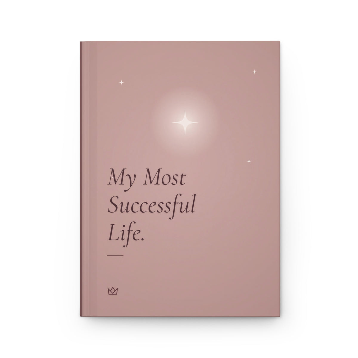Front cover of the dusty rose My Most Successful Life manifestation journal with a glowing four-point star, small stars and the title in italic lettering