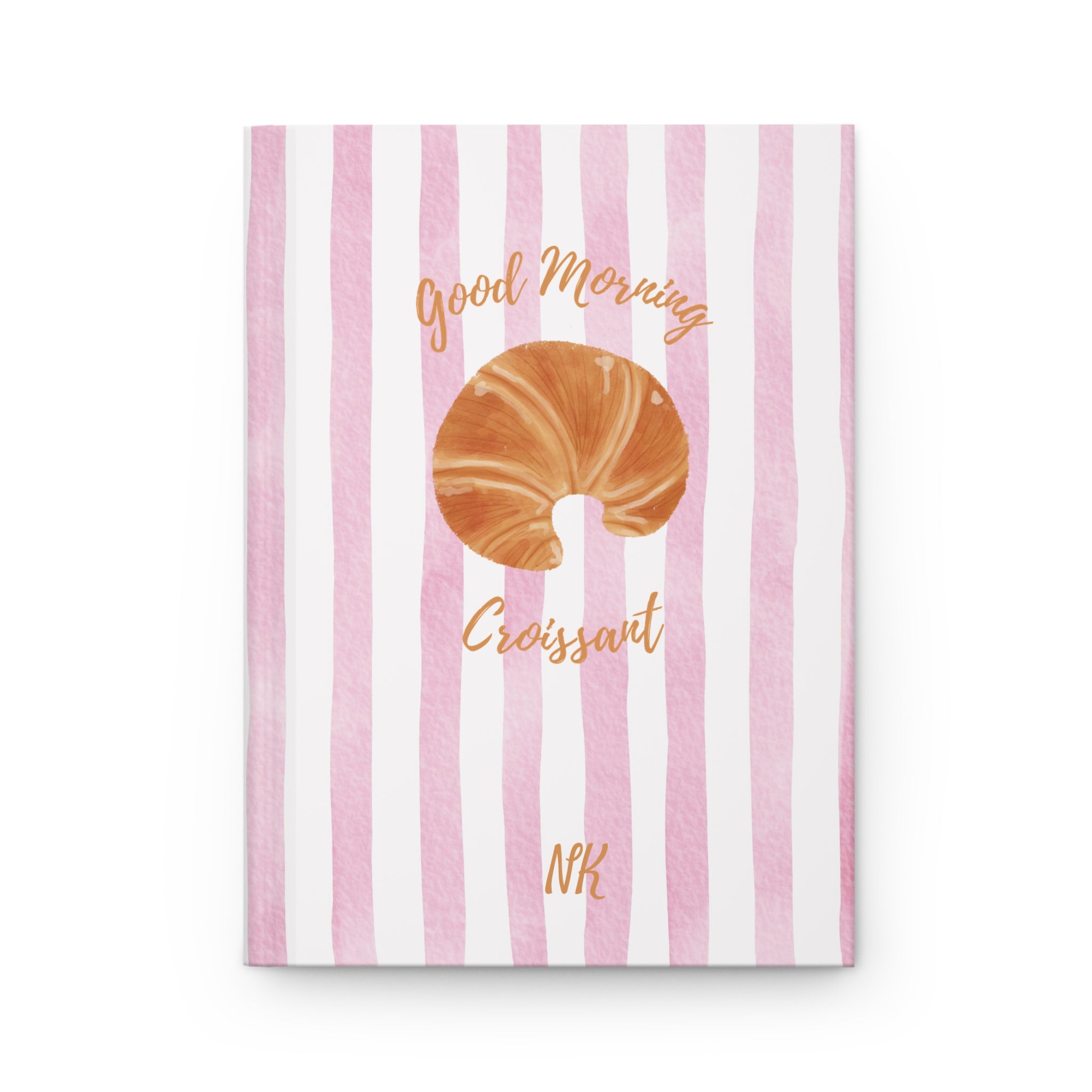 Close-up of Good Morning Croissant journal cover detail with gold script initials on pink stripes