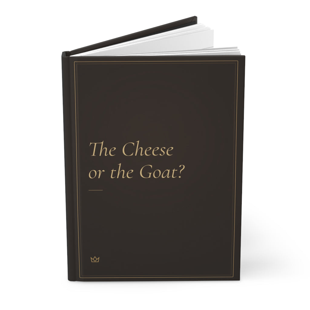 The Cheese or the Goat? hardcover journal standing upright with a pen on top, showing the gold title and dark spine
