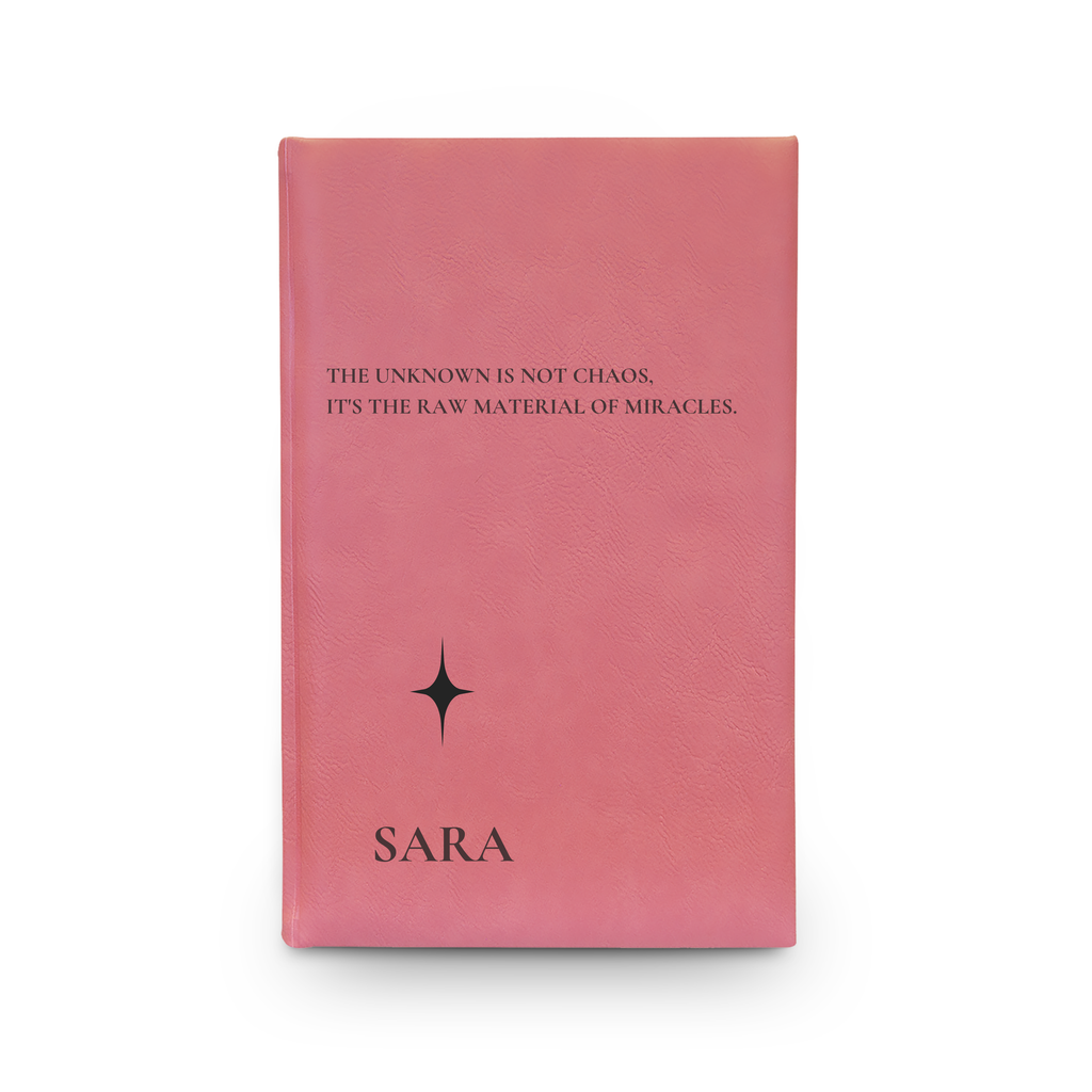 Close-up of the engraved sparkle icon and quote on the vegan leather journal cover