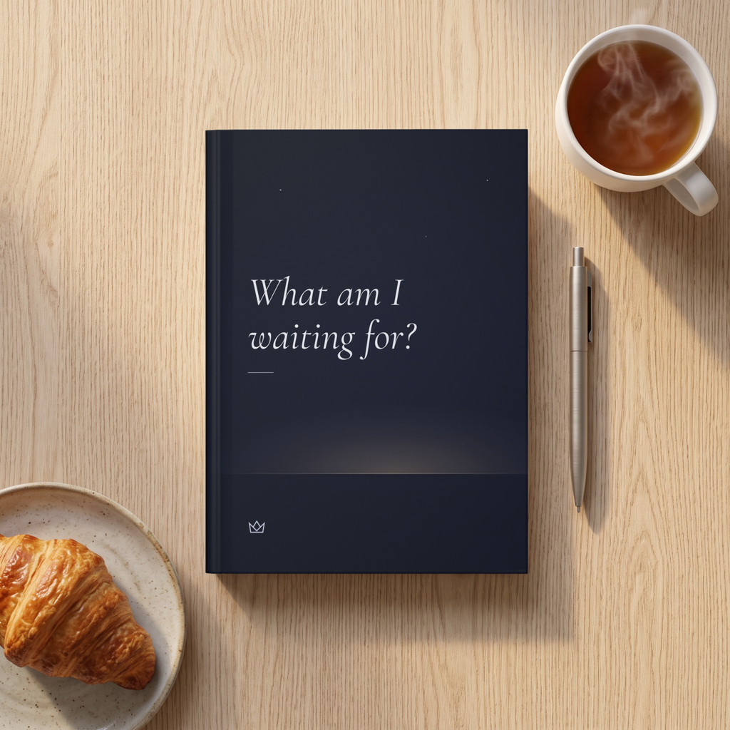 Night-blue What Am I Waiting For? journal on linen with a croissant, a cup of coffee and a pen