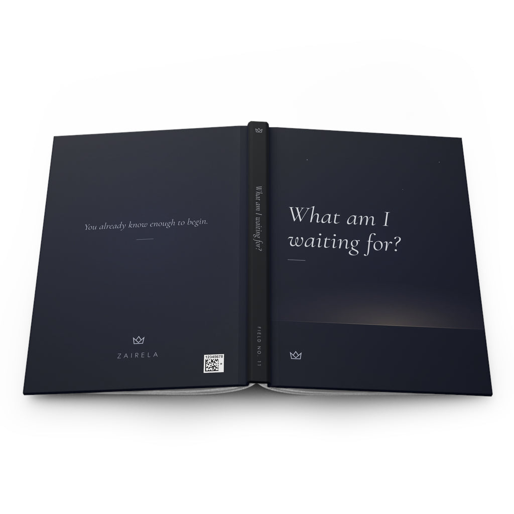 What Am I Waiting For? manifestation journal laid open flat, showing the full wraparound night-blue cover with the back, spine with FIELD NO. 11, and front